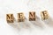 Four wooden cubes with word MEME on white working board