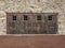 Four Wooden Doors in an Old Stone Wall