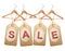 Four wooden hangers with price tags forming the word Sale.