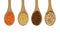 Four wooden spoons full of grains