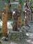 Four wooden statues of ancient Slavonic men - representatives of different crafts against the backdrop of huts from the
