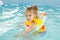 Four-year girl floating in the pool