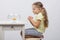 Four-year girl makes a wish sitting in front of a goldfish