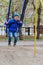 Four-year-old boy riding on an iron swing in the street