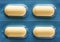 Four yellow oblong pills in a blister