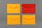 Four yellow and red paper envelopes over grey