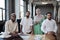 Four young contemporary economists in traditional Muslim clothes