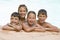 Four young friends in swimming pool smiling