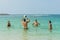 Four young fun people are playing volleyball on the beach at the coast of Dubai. Positive human emotions, feelings, joy. Funny cut