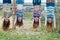 Four young girls hanging upside down in park