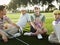 Four young golfers sitting on court