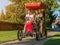 Four young people in a four-wheeled bicycle