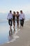 Four Young People, Two Couples, Walking On A Beach