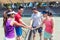 Four young tennis players putting hands together before a doubles mixed match