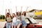 Four young women friends standing near car outdoors.