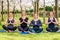 Four young women practicing Lotus Pose