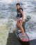 Fourteen year-old Amerasian boy wake surfing on Grand Lake in Oklahoma.