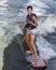 Fourteen year-old Amerasian boy wake surfing on Grand Lake in Oklahoma.