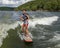 Fourteen year-old Amerasian boy wake surfing on Grand Lake in Oklahoma.