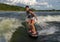 Fourteen year-old Amerasian boy wake surfing on Grand Lake in Oklahoma.