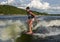 Fourteen year-old Amerasian boy wake surfing on Grand Lake in Oklahoma.