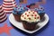 Fourth 4th of July party celebration with red, white and blue chocolate cupcakes closeup.