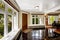 Foyer with black shiny tile floor and stone trim under the windows