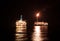 FPSO tanker vessel near Oil Rig at night. Offshore oil and gas industry