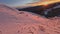 Fpv drone dive from high mountain top evening sunset altitude pink sunny winter nature