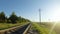 FPV drone flight fast and maneuverable along railway in a clear sunny day