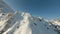 Fpv drone flying upward over snowy slope at winter ski resort. Ski lift on winter cable way at snowy ski resort aerial