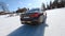 Fpv drone shot of White BMW drifting on ice Hockey Arena