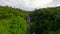 FPV flight over scenic tropical waterfall in the green lush jungle, Thailand