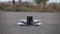 FPV racing drone takes off from the asphalt surface