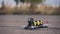 FPV racing drone takes off from the asphalt surface