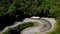 FPV semi truck driving along mountain road going through forest landscape in countryside. F