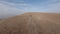 FPV sports drone shot SUV automobile race rally offroad riding desert mountain adventure sand splash