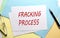 FRACKING PROCESS text on paper on the colorful paper background