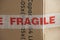 Fragile warning on a cardboard moving box