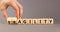 Fragility or agility symbol. Concept words Fragility and Agility on wooden cubes. Businessman hand. Beautiful grey table grey