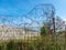 Fragment of barbed wire mounted above prison fence,