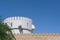 Fragment of bastion fort wall and part of watchtower in Abu Dhabi,UAE. Defensive middle eastern city wall with prongs.