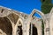 Fragment of Bellapais Abbey, White Abbey, Abbey of the Beautiful world. Arches and cypress against the blue sky