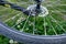 Fragment of bike wheel laying on green grass