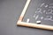 Fragment of Black Chalkboard with Hand Written Simple Mathematics Equations Broken White Chalks. Back to School Concept