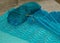 A fragment of a blue knitted sweater of different shades, leisure concept, handmade