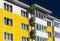 Fragment of brightly colored apartment building with balconies