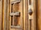 Fragment of brown wooden door in monastery, close up view. Door with cross and decorative carvings. Ancient wooden door