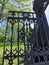 A fragment of the cast-iron gate of the Summer Garden of the city of Kronstadt against the background of a blue cloudless sky