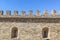 Fragment of a castle wall of a fortress fortification made of natural stone.